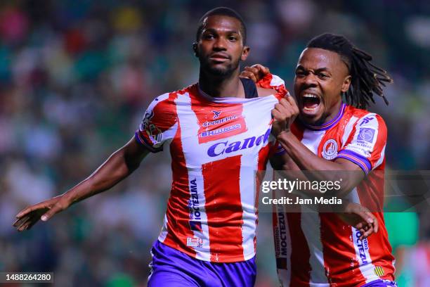 Vitor Ferreira of San Luis celebrates with teammate Jhon Murillo after scoring the team's third goal during the playoff match between Leon and...