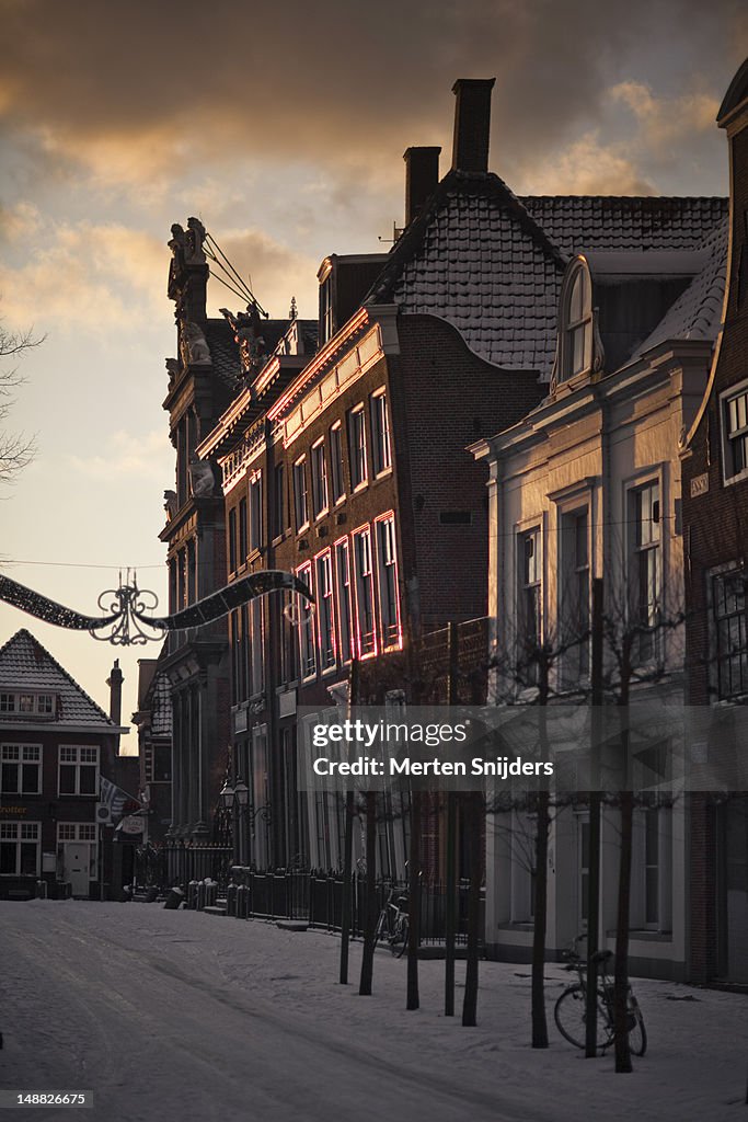 Grote Noord street and Roode Steen covered in snow, with sunlight on Westfries museum.