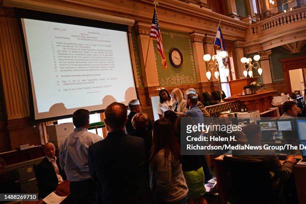 Colorado Representatives meet during a brief recess during debates over amendments to SB23-303 in the House chambers in the Colorado State Capitol on...