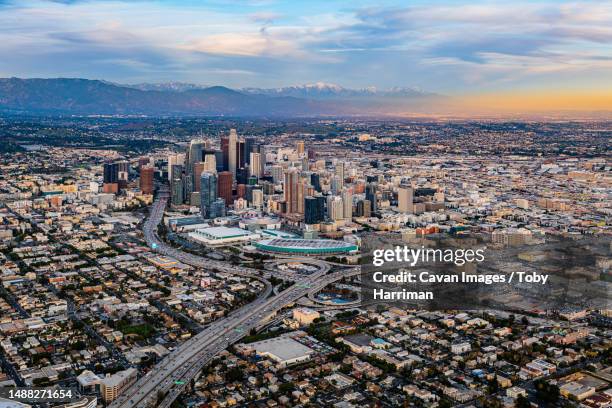 downtown los angeles snow peaked mountains aerial sunset - los angeles stock-fotos und bilder