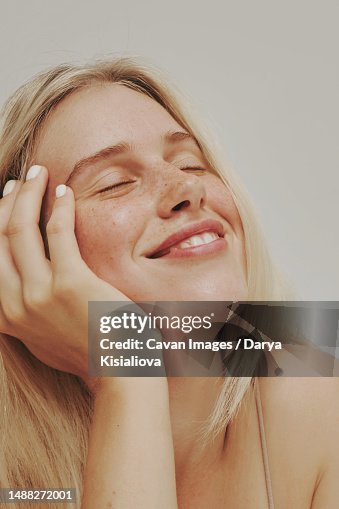 Freckles blonde blue-eyed woman, perfect skin smiling Freckles blonde blue-eyed woman, perfect skin smiling