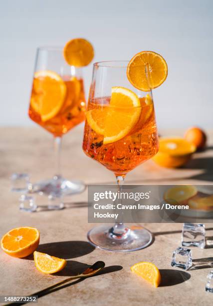 close up of two spritz drinks on sunny beige background - aperol spritz fotografías e imágenes de stock