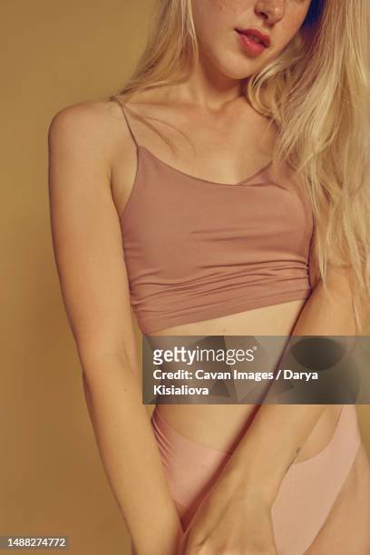 a young blonde freckles girl in a beige lingerie with long hair - hot fitness models female stock pictures, royalty-free photos & images