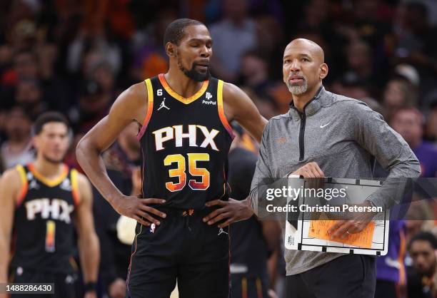 Kevin Durant and head coach Monty Williams of the Phoenix Suns talk during the second half of Game Four of the NBA Western Conference Semifinals at...