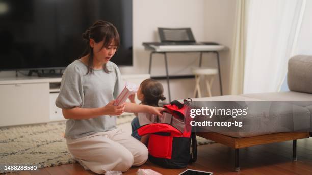 woman preparing emergency bag at home - crisis planning stock pictures, royalty-free photos & images