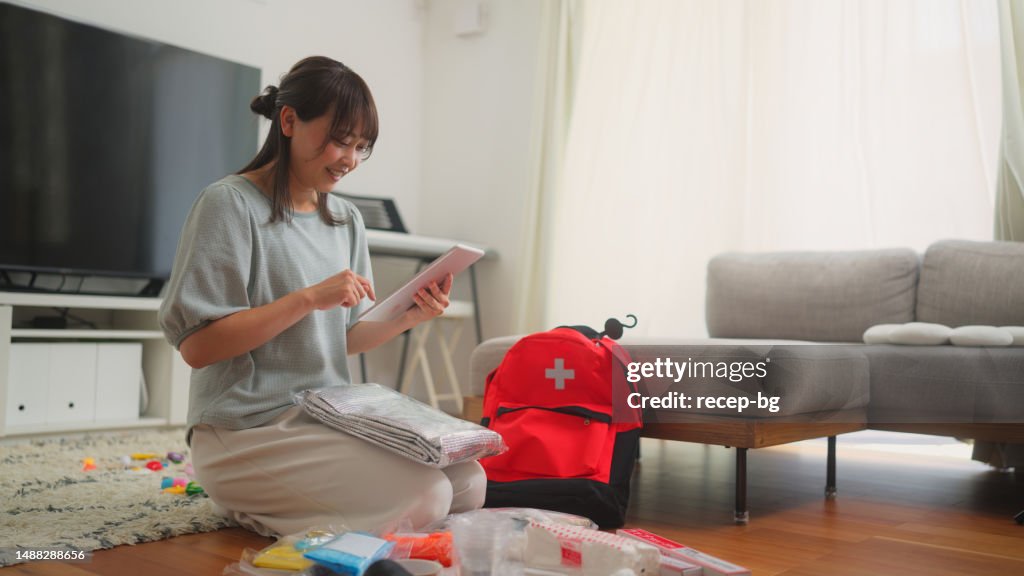 Woman preparing emergency bag at home
