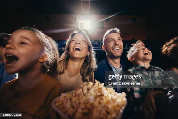 cheerful family having fun in movie theatre. - cinematografi bildbanksfoton och bilder