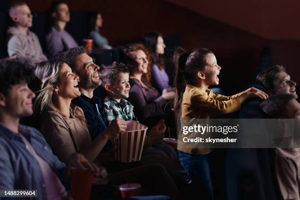 enjoying in movie projection at cinema! - girls boys opening night stock pictures, royalty-free photos & images