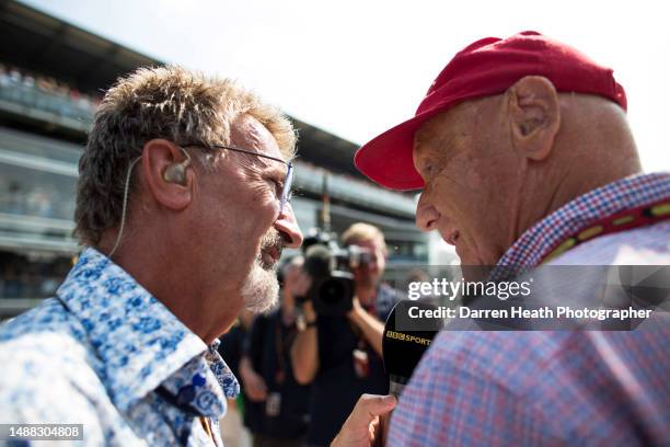 Close-up photograph of spectacle wearing, microphone holding, Irish BBC television expert pundit and ex-Formula One team owner Eddie Jordan...