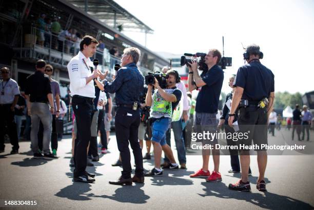 Microphone holding Irish BBC television expert pundit and ex-Formula One team owner Eddie Jordan interviewing Austrian Mercedes-AMG team principal...