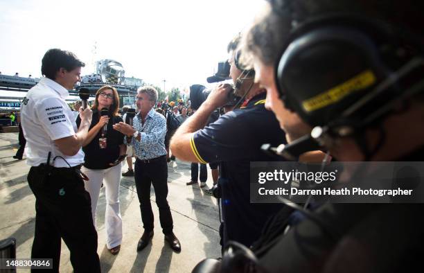 Flower patterned shirt wearing, microphone holding Irish BBC television expert pundit and ex-Formula One team owner Eddie Jordan interviewing...