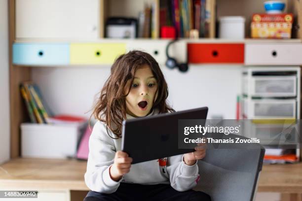 cute boy using a digital tablet - thanasis zovoilis stock pictures, royalty-free photos & images
