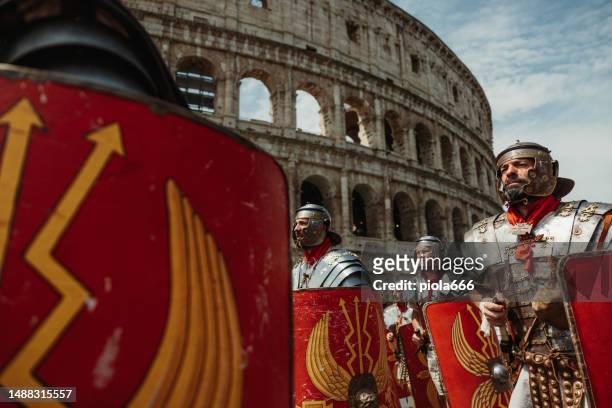 gladiators parade under the coliseum of rome - rome empire stock pictures, royalty-free photos & images