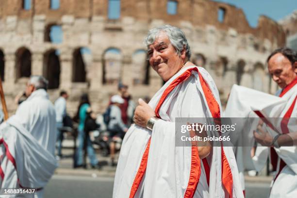 défilé d’anciens sénateurs romains sous le colisée de rome - centurion photos et images de collection