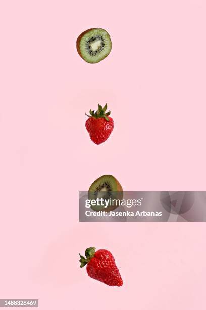 flying  strawberries and kiwi - flying kiwi stock pictures, royalty-free photos & images