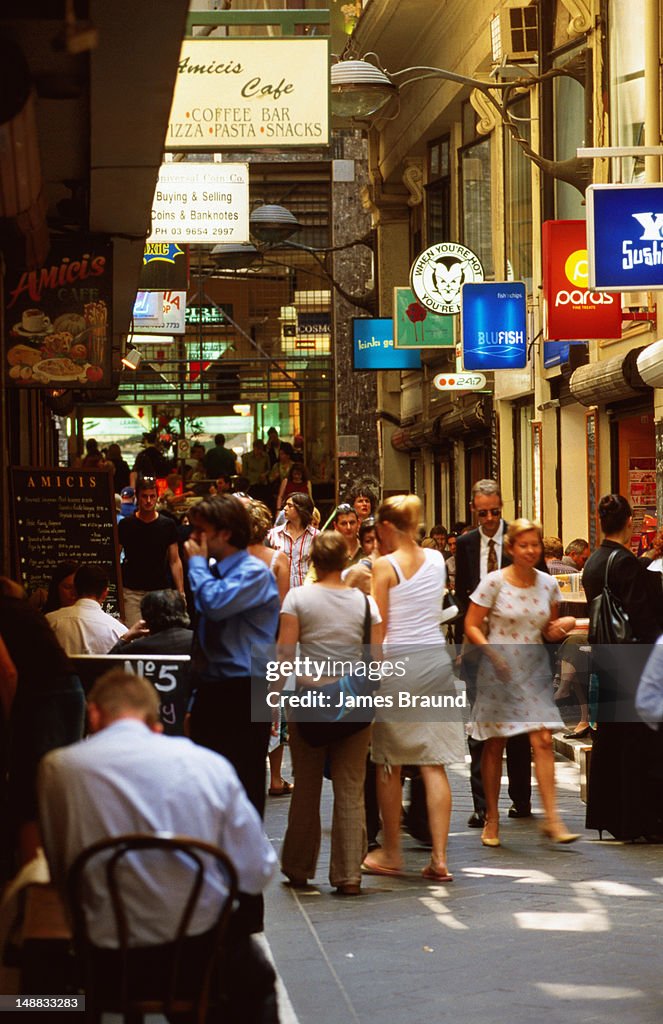 Pedestrians and diners in Centre Way Arcade in city.