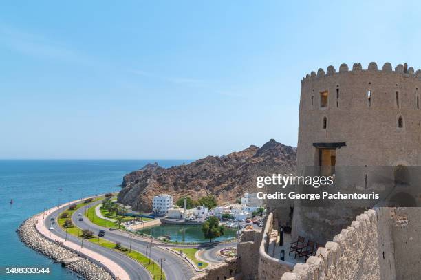 view of the corniche and the mutrah fort in muscat, oman - gulf of oman stock pictures, royalty-free photos & images