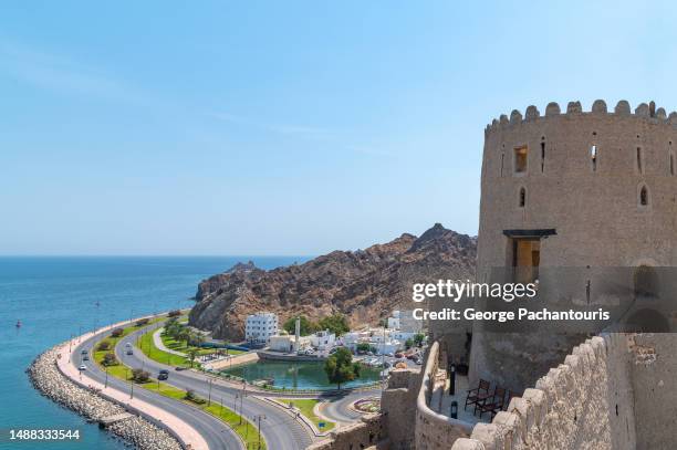 view of the corniche and the mutrah fort in muscat, oman - matrah fort stock pictures, royalty-free photos & images