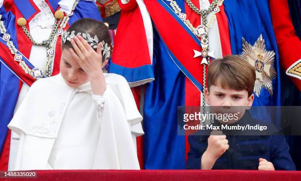 Princess Charlotte of Wales and Prince Louis of Wales watch an RAF flypast from the balcony of Buckingham Palace following the Coronation of King...