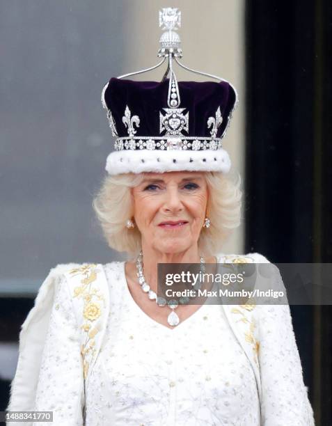 Queen Camilla watches an RAF flypast from the balcony of Buckingham Palace following her and King Charles III's Coronation at Westminster Abbey on...