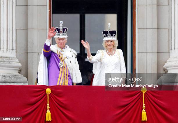 King Charles III and Queen Camilla wave from the balcony of Buckingham Palace, whilst watching an RAF flypast, following their coronation at...