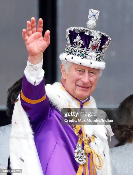 King Charles III watches an RAF flypast from the balcony of Buckingham Palace following his and Queen Camilla's Coronation at Westminster Abbey on...