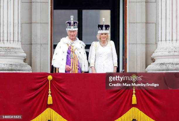 King Charles III and Queen Camilla watch an RAF flypast from the balcony of Buckingham Palace following their coronation at Westminster Abbey on May...