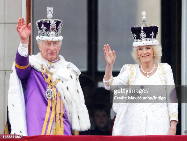 King Charles III and Queen Camilla wave from the balcony of Buckingham Palace, whilst watching an RAF flypast, following their coronation at...