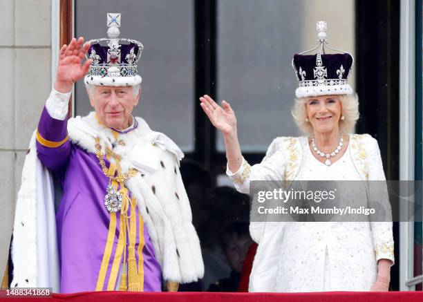 King Charles III and Queen Camilla wave from the balcony of Buckingham Palace, whilst watching an RAF flypast, following their coronation at...