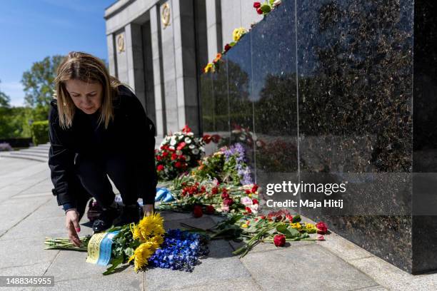 Zoya Sayin from Ukraine living in Germany lays flowers at Soviet War Memorial Tiergarten to commemorate the 1945 liberation of Germany from fascism...