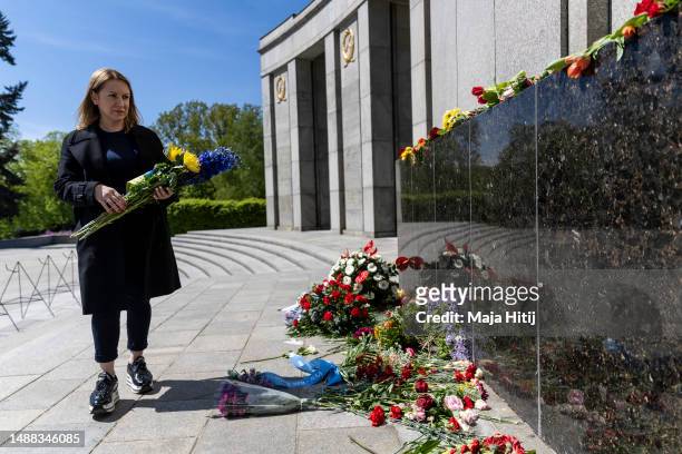 Zoya Sayin from Ukraine living in Germany lays flowers at Soviet War Memorial Tiergarten to commemorate the 1945 liberation of Germany from fascism...