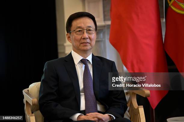 The Vice President of China Han Zheng sits in front of national flags with Portuguese Prime Minister Antonio Costa upon his arrival for a bilateral...