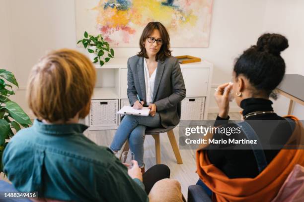 couple discussing problems with therapist - conflict stock pictures, royalty-free photos & images