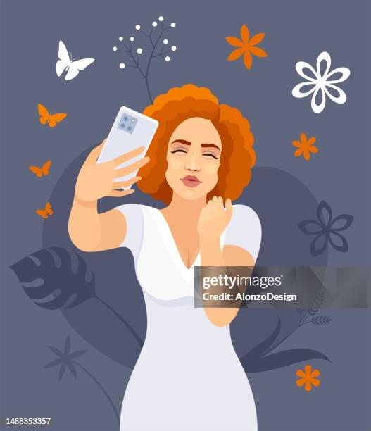 selfie photo of a beautiful redhead woman. young woman is taking a selfie and blowing a kiss. maintaining social networks. - blowing a kiss stock illustrations