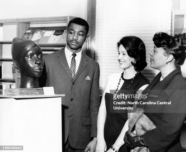 James Newton, North Carolina College senior art major, talking with R. D. Newman and Hilda Johnson at the opening of a Student Art Exhibition.
