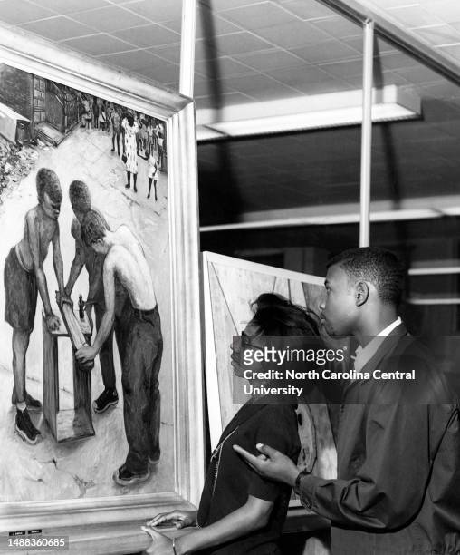 North Carolina College students Constance Thornton, sophomore, of Durham, and Charles Council, freshman, of Greenville, N.C., viewing painting by...