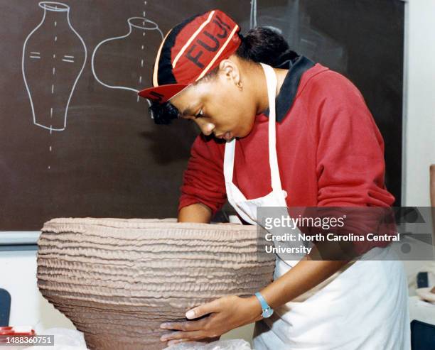 North Carolina Central University student molding clay in pottery class.