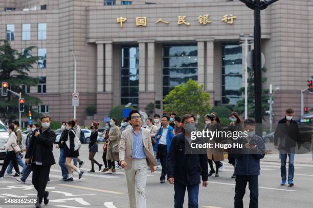 People walk infront of People's Bank of China at Lujiazui on May 08, 2023 in Shanghai, China.