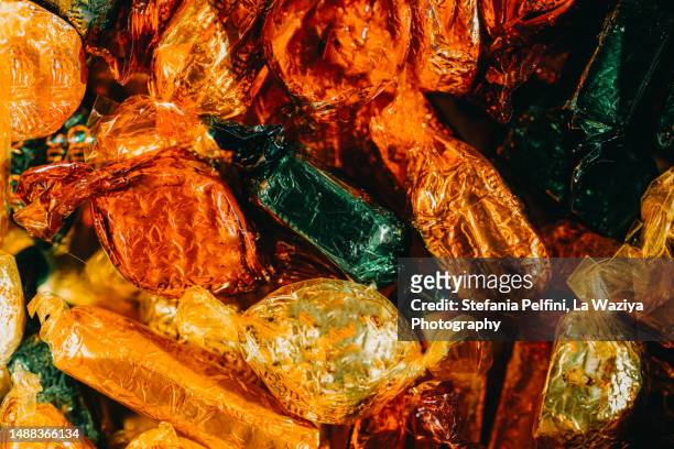 full frame of wrapped candies - candy wrapper stock-fotos und bilder