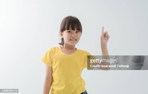 image of asian child posing on white background - child pointing stock pictures, royalty-free photos & images