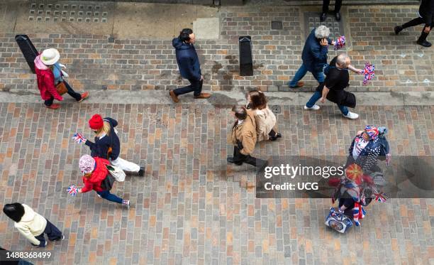 Looking down on monarchists and supporters of the Bristiah royal family in London. The streets of London were alive with a festive atmosphere as...