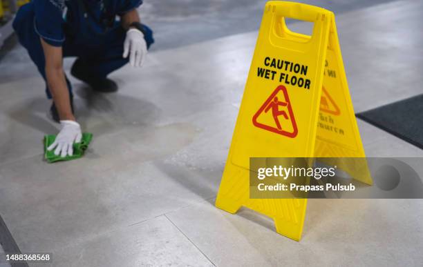 wet floor caution sign on floor - osha placard stock pictures, royalty-free photos & images