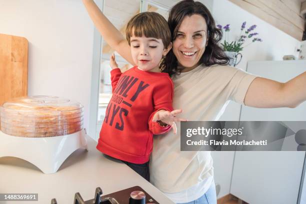 mother and son cooking together - italian mother kitchen stock pictures, royalty-free photos & images