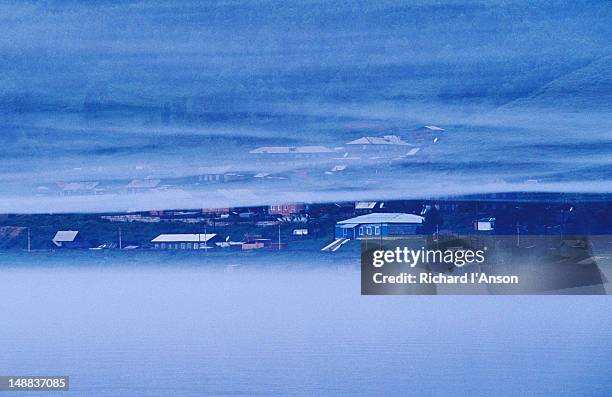 low cloud engulfs the lake & houses at port baikal. - engulfs stock pictures, royalty-free photos & images