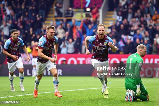 Ashley Barnes of Burnley celebrates after scoring the team's second goal as Ryan Allsop of Cardiff City looks on after failing to make a save during...