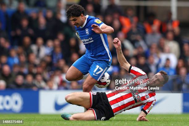 Reda Khadra of Birmingham City is tackled by Chris Basham of Sheffield United during the Sky Bet Championship between Birmingham City and Sheffield...