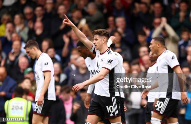 Tom Cairney of Fulham celebrates with teammates after scoring the team's third goal during the Premier League match between Fulham FC and Leicester...