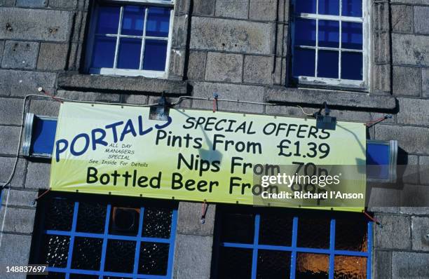 a banner advertising special offers above the entrance to a pub in the city centre. - aberdeen scotland city stock pictures, royalty-free photos & images