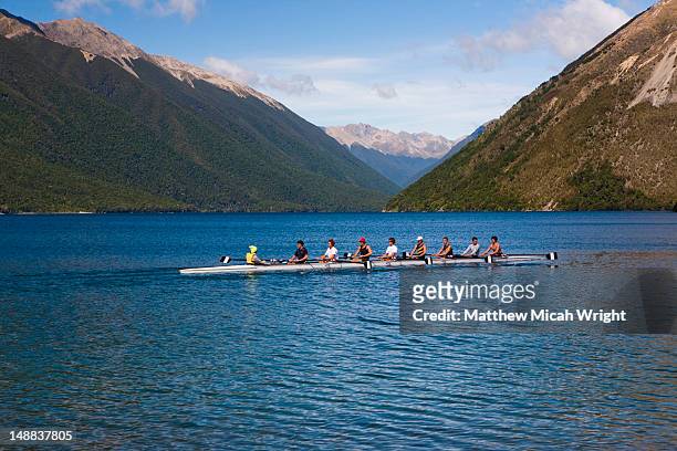lake rotoiti is lake in the tasman region of new zealand. it is a mountain lake within in the nelson lakes national park. locals practice rowing their waka across the lake - nelson lakes national park stock pictures, royalty-free photos & images