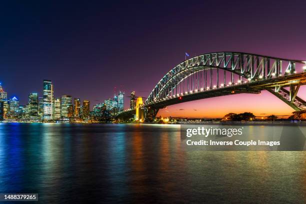 scene of sydney cityscape riverbank with sydney harbor bridge beside sydney opera house at the twilight time - sydney harbour stock pictures, royalty-free photos & images